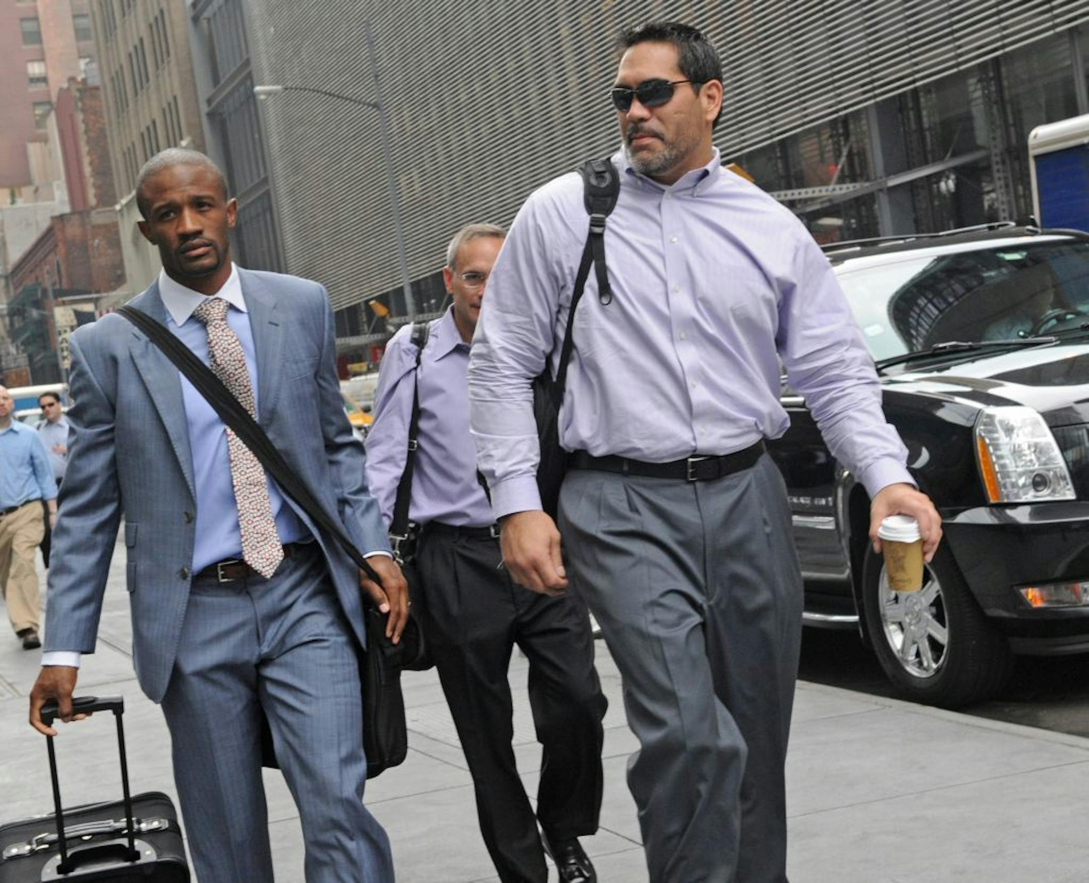 Former Tennessee Titans center and NFL Players Association President Kevin Mowae, right, enters a Manhattan law office, Friday, July 8, 2011, in New York. Members of the NFL Players' Association executive board and owners are meeting in hopes of resolving a lockout that began in March.