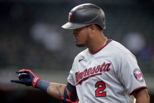 Minnesota Twins' Luis Arraez gestures after hitting an RBI single during the fourth inning of an Opening Day baseball game against the Milwaukee Brewe