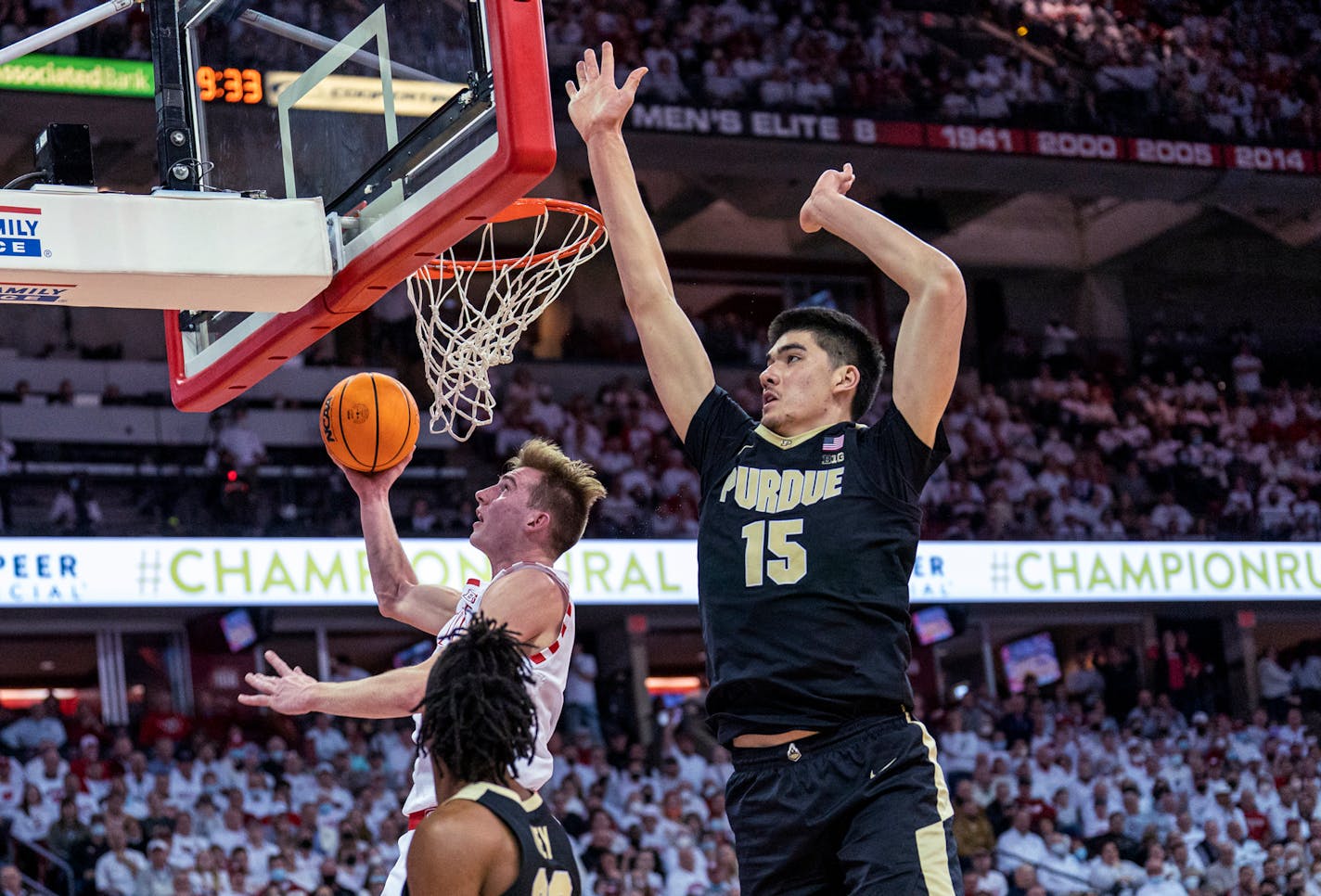 Wisconsin's Tyler Wahl (5) shoots as Purdue's Jaden Ivey (23) and Zach Edey, right, watch during the second half of an NCAA college basketball game Tuesday, March 1, 2022, in Madison, Wis. Wahl had a team-high 19 points in Wisconsin's 70-67 win. (AP Photo/Andy Manis)