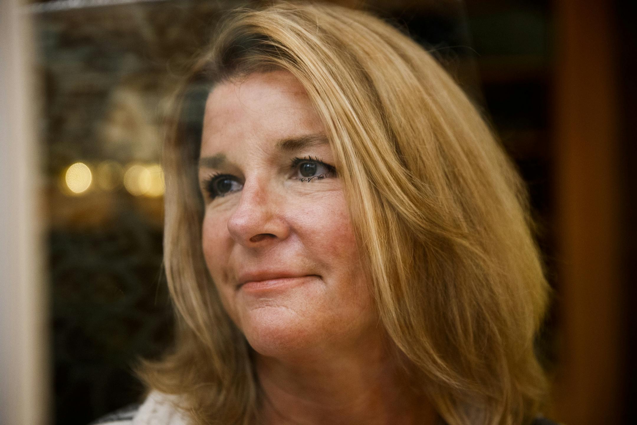 Kim Filian, 54, poses for a portrait in her home Wednesday Dec. 19, 2018, in Barrington, Ill. Filian purchased around four dozen Pride flags after learning that her neighbor's, Casey Handal, 40, and her partner Zadette Rosado, 42, Pride flag was removed from their backyard and replaced by an American flag. (Armando L. Sanchez/Chicago Tribune/TNS) ORG XMIT: 1259897 ORG XMIT: MIN1812201010091931