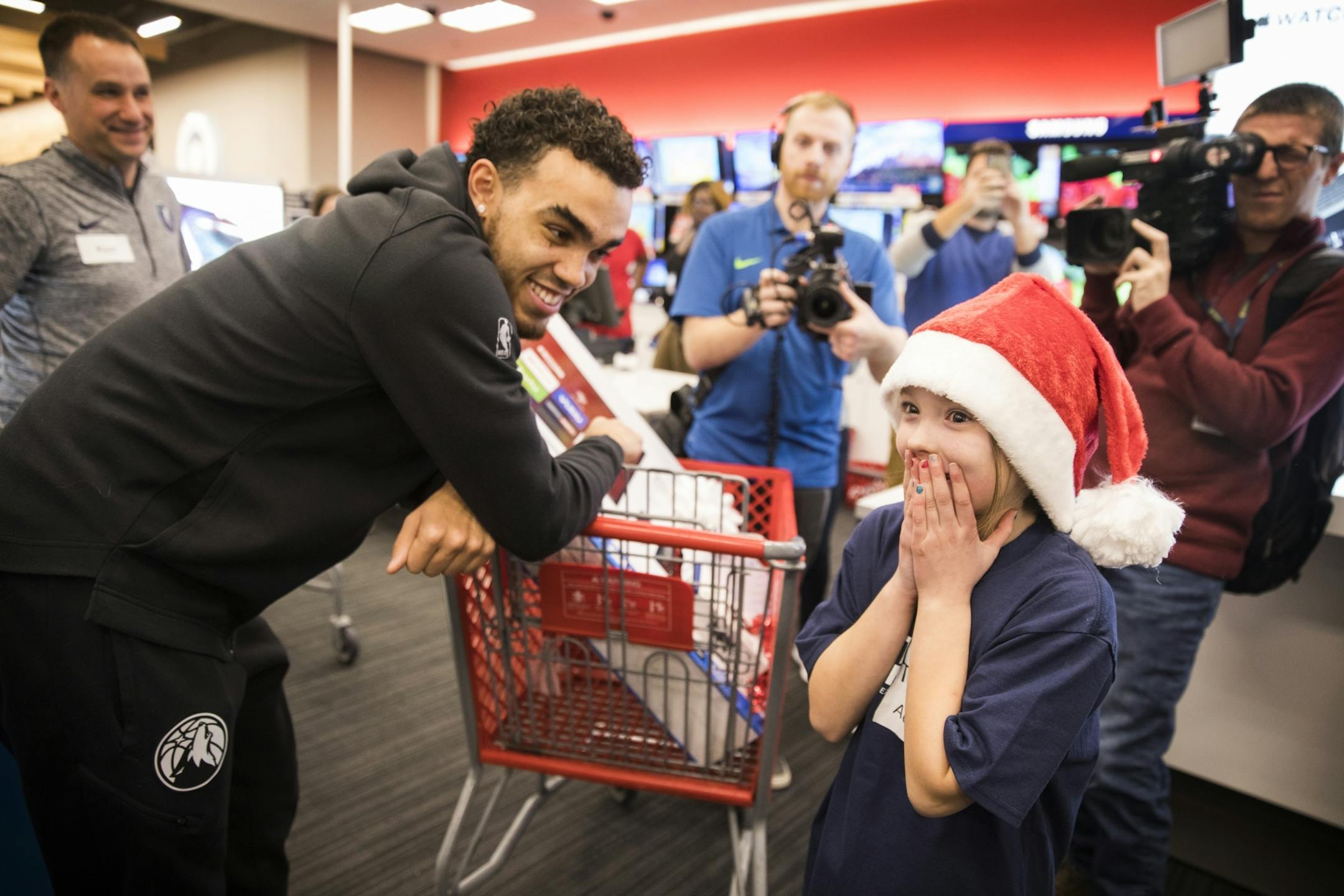 Timberwolves player Tyus Jones shops with Addison Warden, 9, of Maple Grove, who's mother is going to soon be deployed overseas with the Minnesota Army National Guard. Warden was just surprised with free tickets to a Timberwolves game and a Fitbit for her mom.