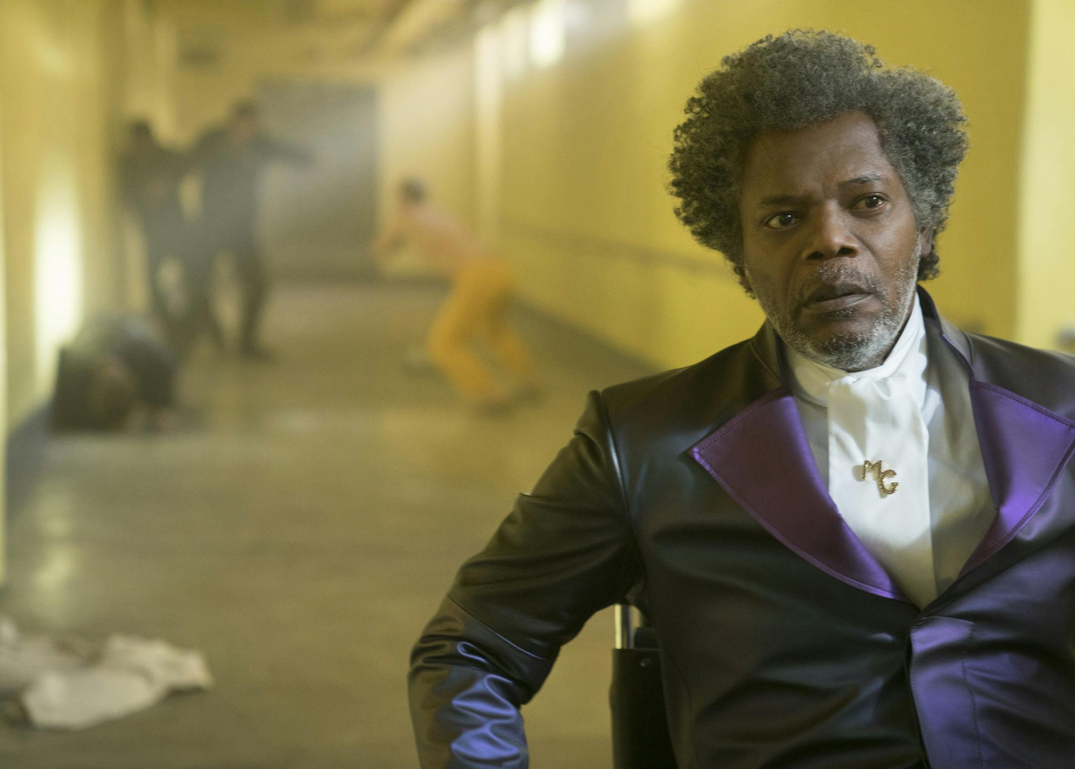 Samuel L. Jackson as Elijah Price/Mr. Glass and James McAvoy (background, in yellow) as Kevin Wendell Crumb/The Horde in "Glass," written and directed by M. Night Shyamalan.