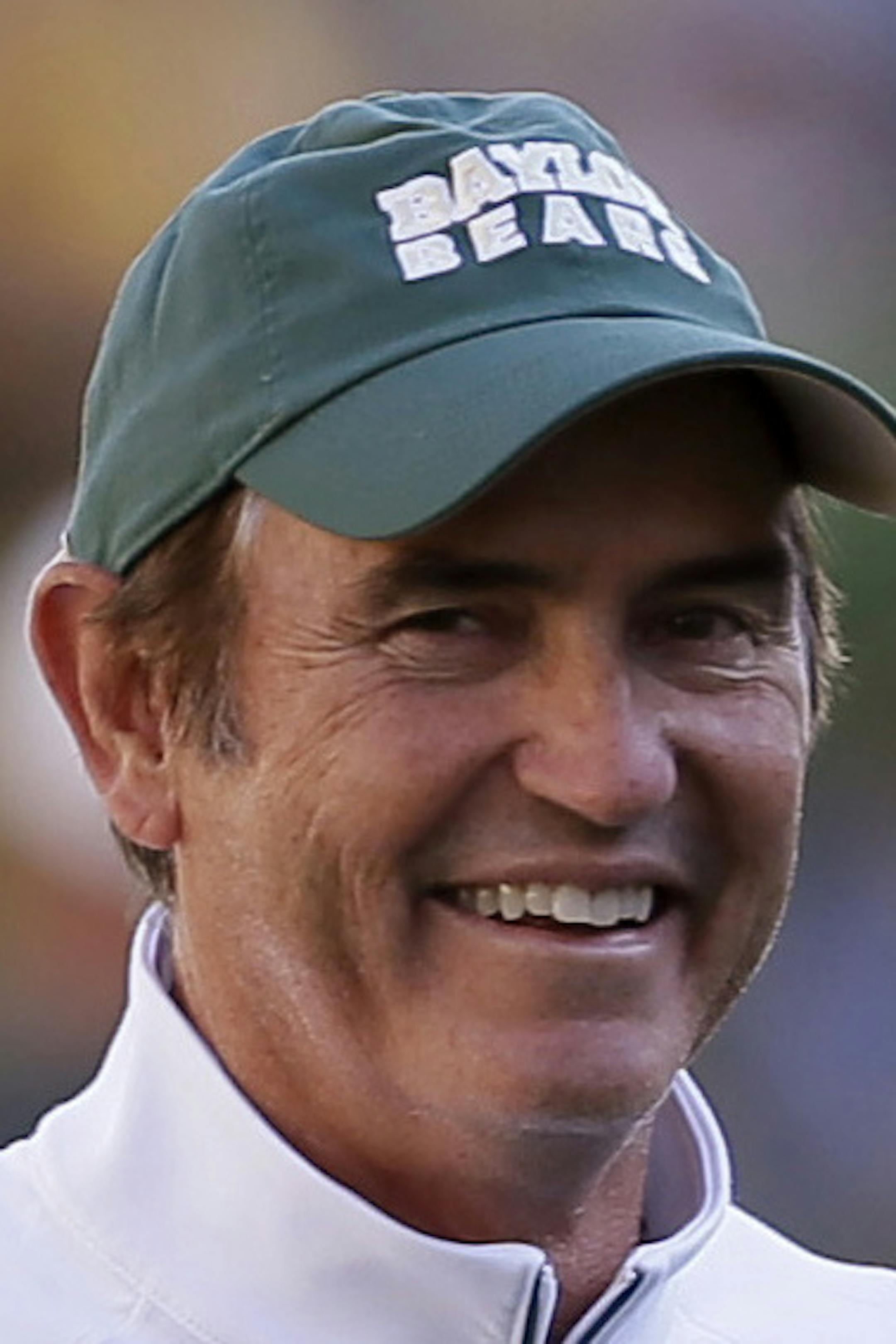 FILE - In this Sept. 12, 2015, file photo, Baylor quarterback Seth Russell (17) warms up as coach Art Briles watches before an NCAA college football game against Lamar in Waco, Texas. Baylor's spread is spreading, and weakening opposing defenses. The top three FBS teams in total offense three weeks into the season are Baylor and two programs (Bowling Green and Tulsa) led by proteges of coach Briles. His player-friendly system is easily transferrable and highly effective. (AP Photo/LM Otero, File