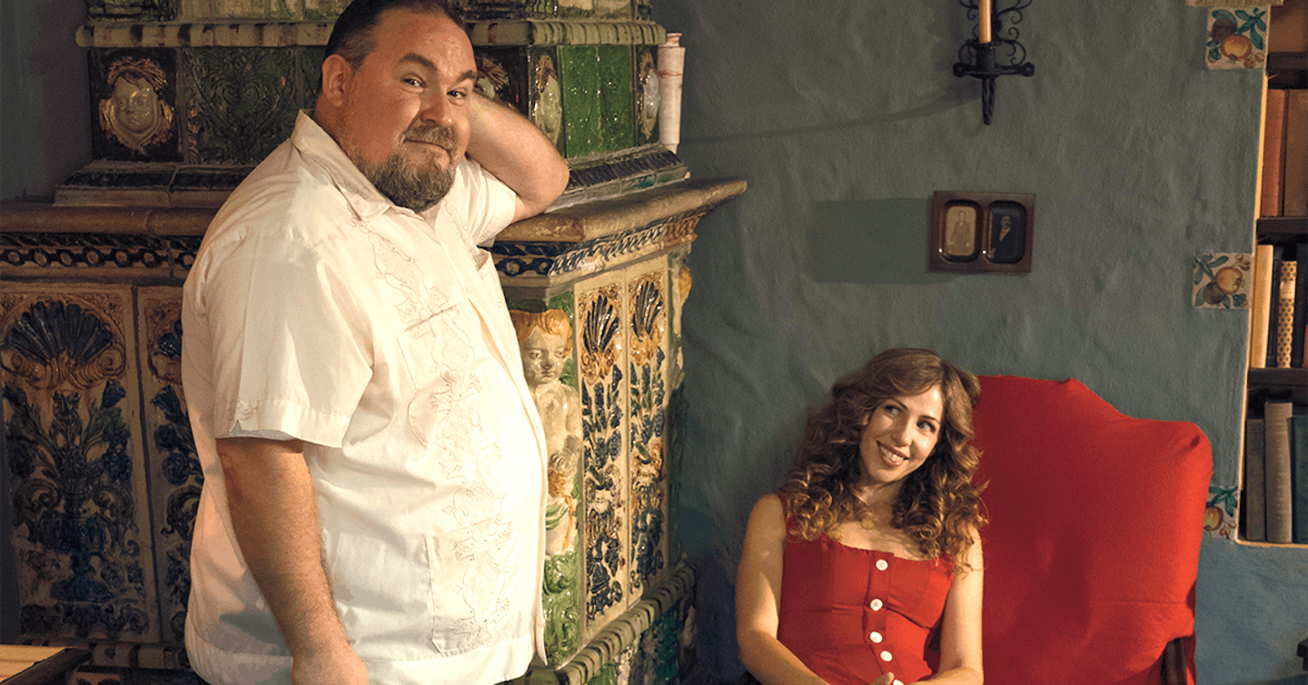 It's Rachael & Vilray, with the guitarist Vilray standing in front of a vintage chest and singer Rachael Price seated on a chair, making eyes at him.