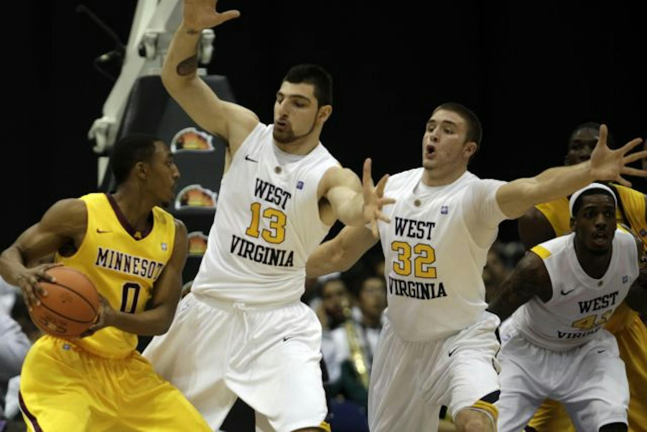Gophers guard Al Nolen looked to pass around West Virginia's Deniz Kilicli (13) on Sunday. Nolen had 17 points.