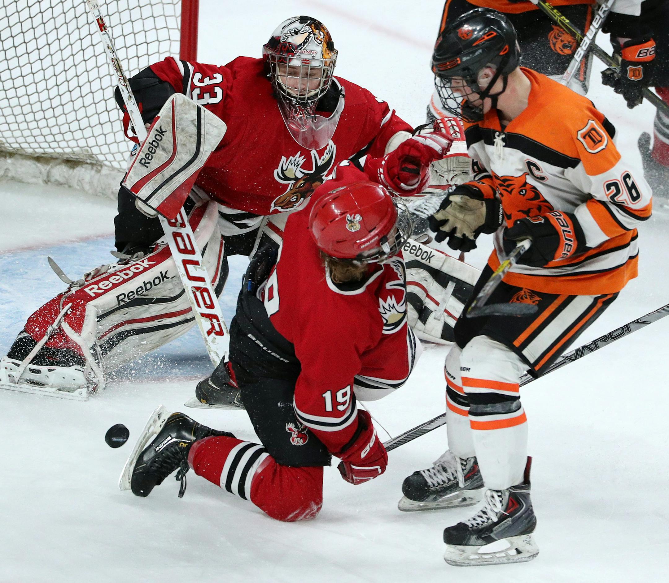 Monticello's Charlie Voller (19) collided with Delano's Brian Halonen (26) as goaltender Tyler Klatt (33) watched the puck in the third period. ] ANTHONY SOUFFLE ï anthony.souffle@startribune.com Players competed during the boys' hockey state tournament Class 1A quarterfinals Wednesday, March 8, 2017 at the Xcel Energy Center in St. Paul, Minn.