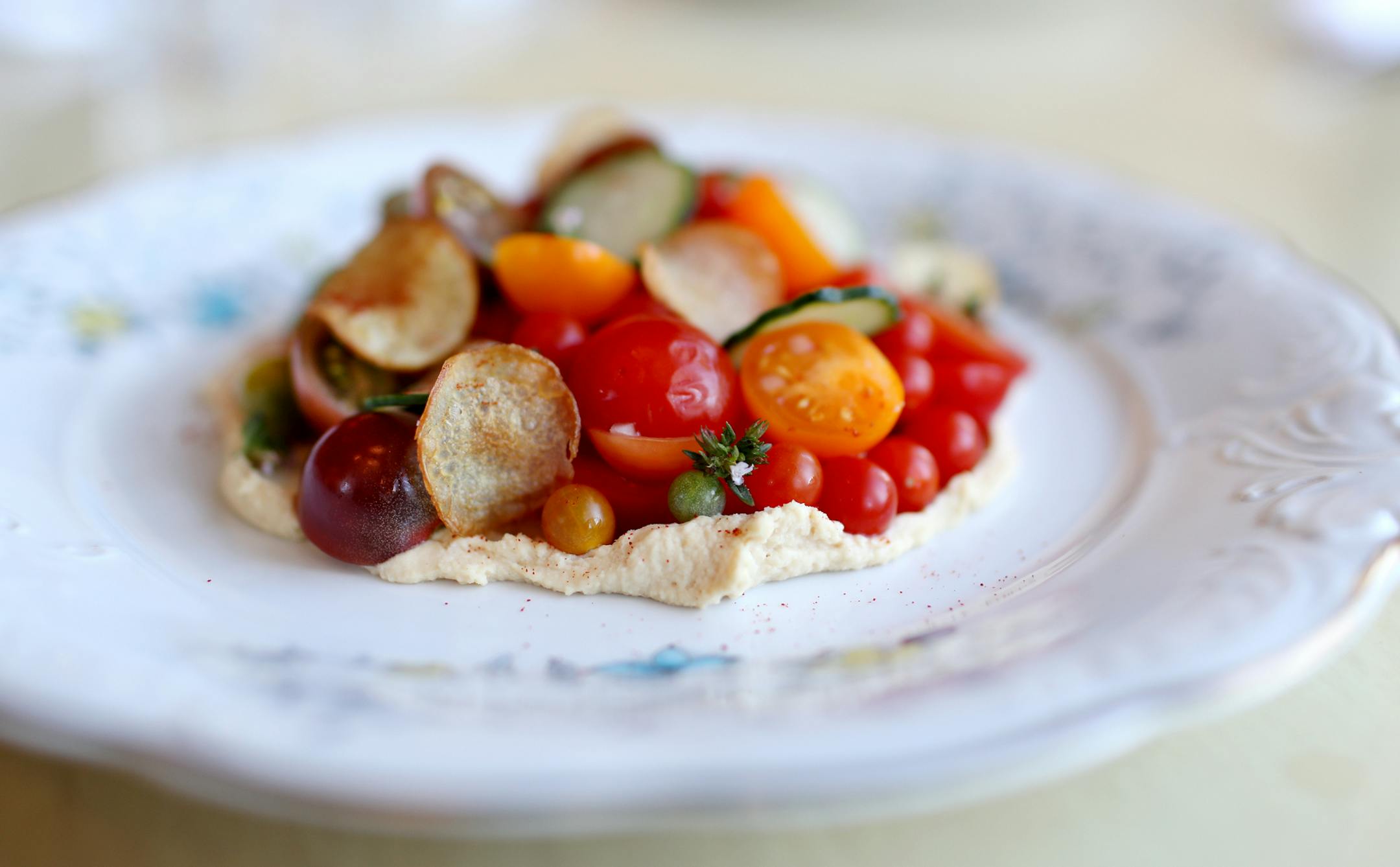 Tomato salad and hummus with cucumbers and potato chips at Blackbird Cafe.