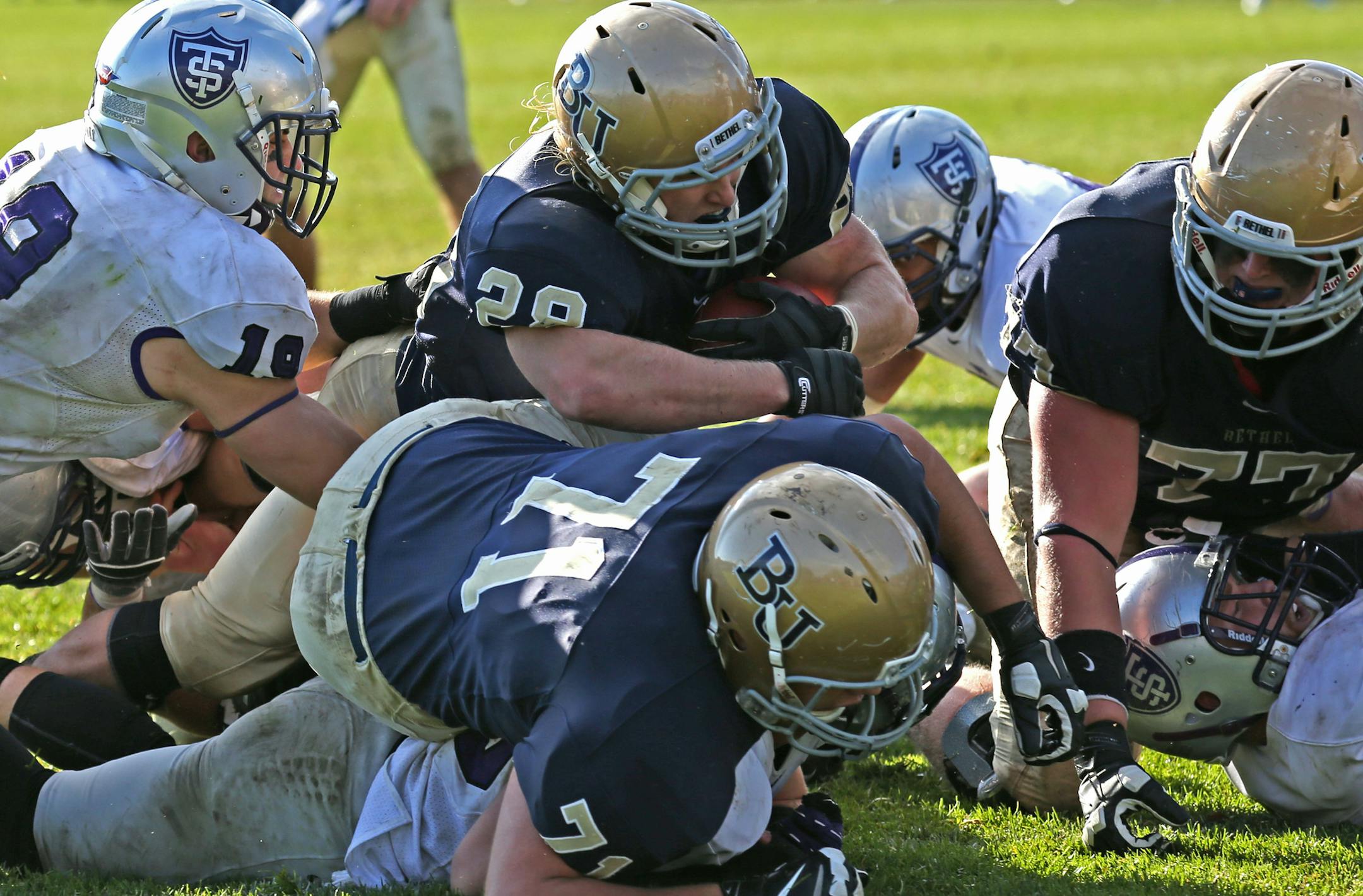 University of st. Thomas vs. Bethel University, 10/19/13. (center) Bethel University running back Marshall Klitzke dove over the middle to score the winning touchdown against the St. Thomas defense, late in the 4th quarter.] Bruce Bisping/Star Tribune bbisping@startribune.com Marshall Klitzke/roster. ORG XMIT: MIN1310191722080132