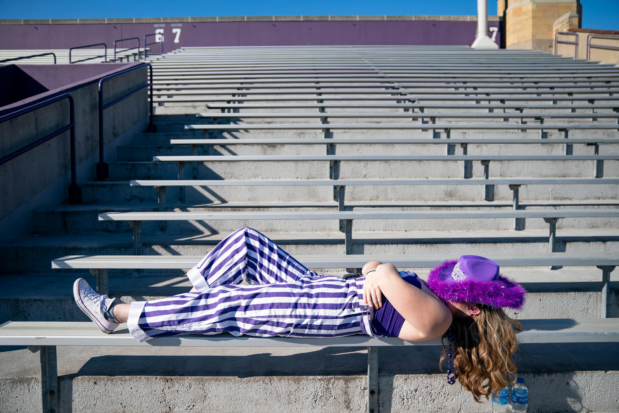 A St.Thomas student rests ahead of the football game against San Diego.
