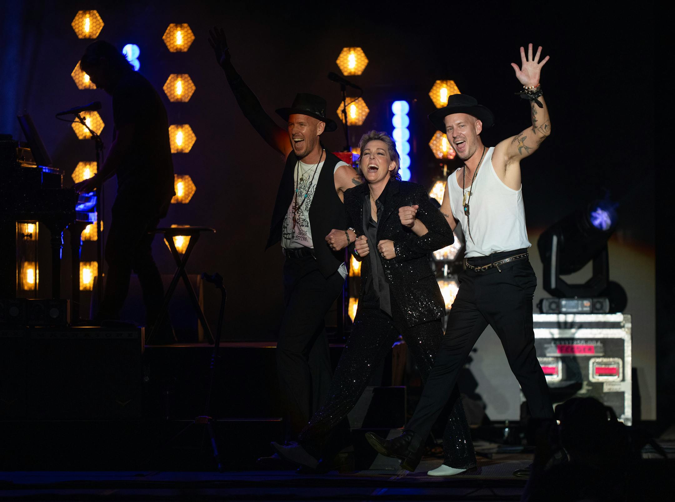 Brandi Carlile was escorted on stage by her sidemen Phillip John Hanseroth and his twin brother Timothy Jay Hanseroth, right, to begin their set at the State Fair Grandstand. With Wynonna Judd opening, Brandi Carlile headlined a sold out show at the State Fair Grandstand Tuesday night, August 29, 2023 in Falcon Heights.