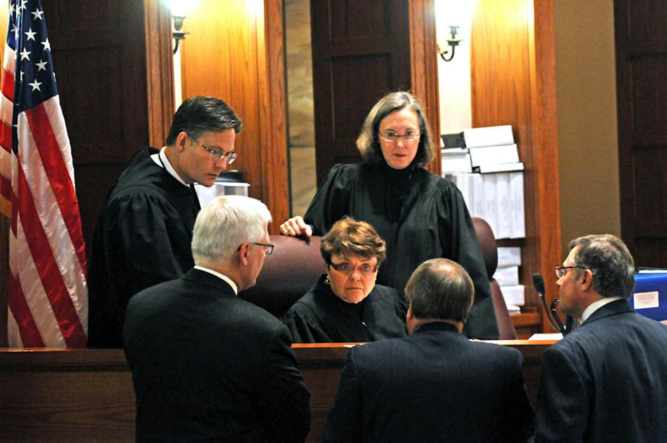 Minnesota Judges Kurt Marben, left, Elizabeth Hayden, center and Denise Reilly, confer with Al Franken's attorney David Lillehaug and former Senator Norm Coleman's attorneys Joe Friedberg, and Tony Trimble, right, during Minnesota's U.S. Senate vote recount trial in St. Paul, Minn., at the Minnesota Judicial Center on March 9 , 2009. Coleman had challenged the State Canvassing Board certification of Franken as the top vote getter.