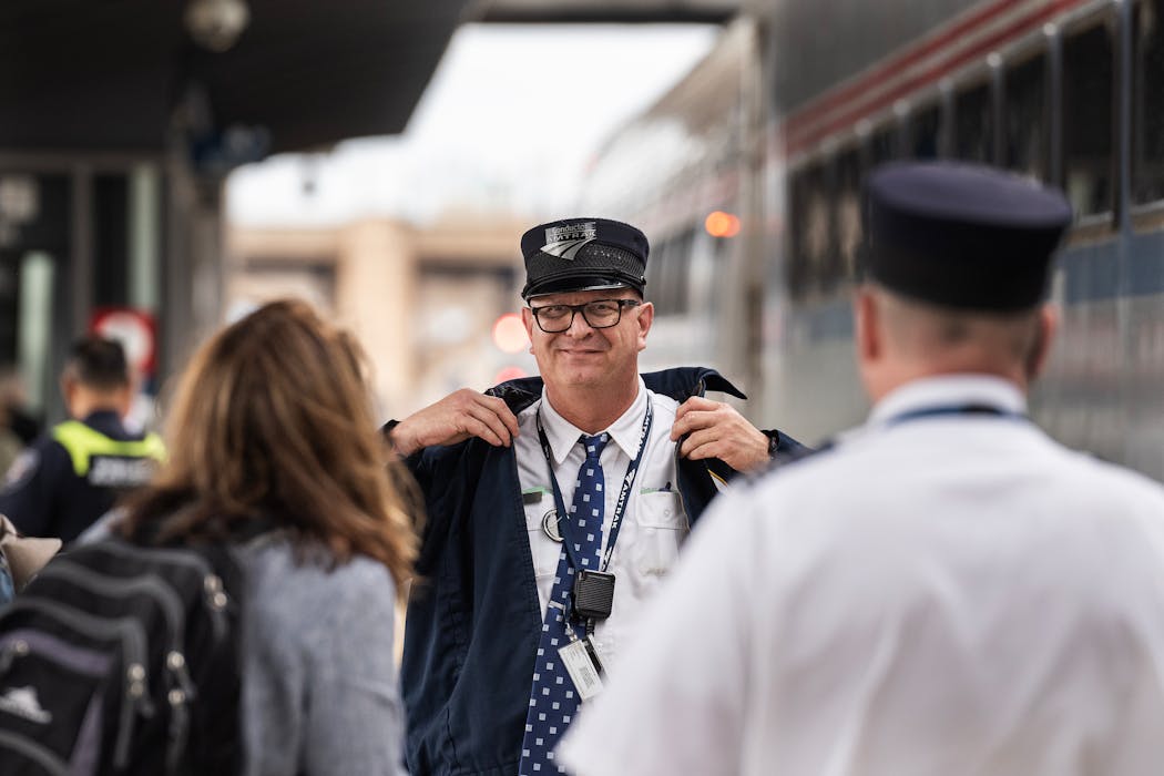 Conductor Roy Gentry welcomes passengers as Amtrak’s Borealis daily service to Chicago begins from St. Paul’s Union Depot on Tuesday.