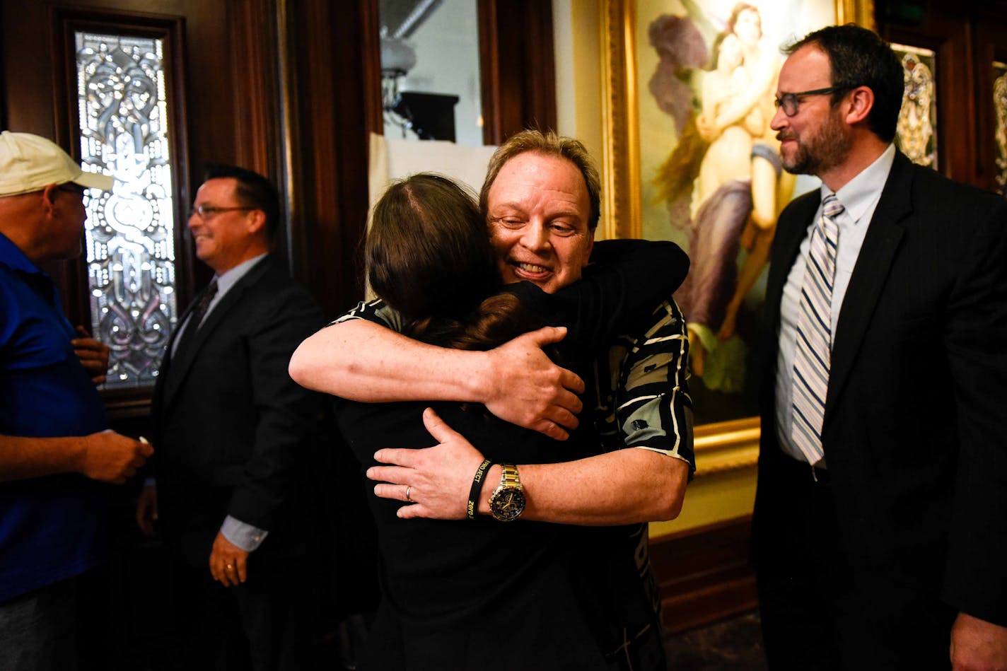 Childhood abuse survivor Jamie Heutmaker embraced bankruptcy attorney Brittany Michael after Thursday's news conference detailing the settlement reached between abuse survivors and the Archdiocese of St. Paul and Minneapolis.