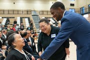 Sao Lou Vu, Tou Ger Xiong's mother, greeted St. Paul Mayor Melvin Carter before a vigil to celebrate the life of her son Saturday, Dec. 23, 2023, at E