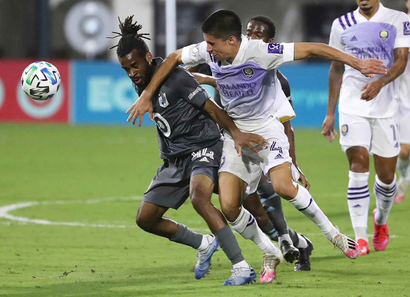 Minnesota United's Raheem Edwards, left, and Orlando City's Joao Moutinho (4) battle for positon on the ball during the MLS is Back tournament at Disney's ESPN Wide World of Sports in Orlando, Florida, on Thursday, Aug. 6, 2020. Orlando City won, 3-1. (Stephen M. Dowell/Orlando Sentinel/TNS) ORG XMIT: 1736376