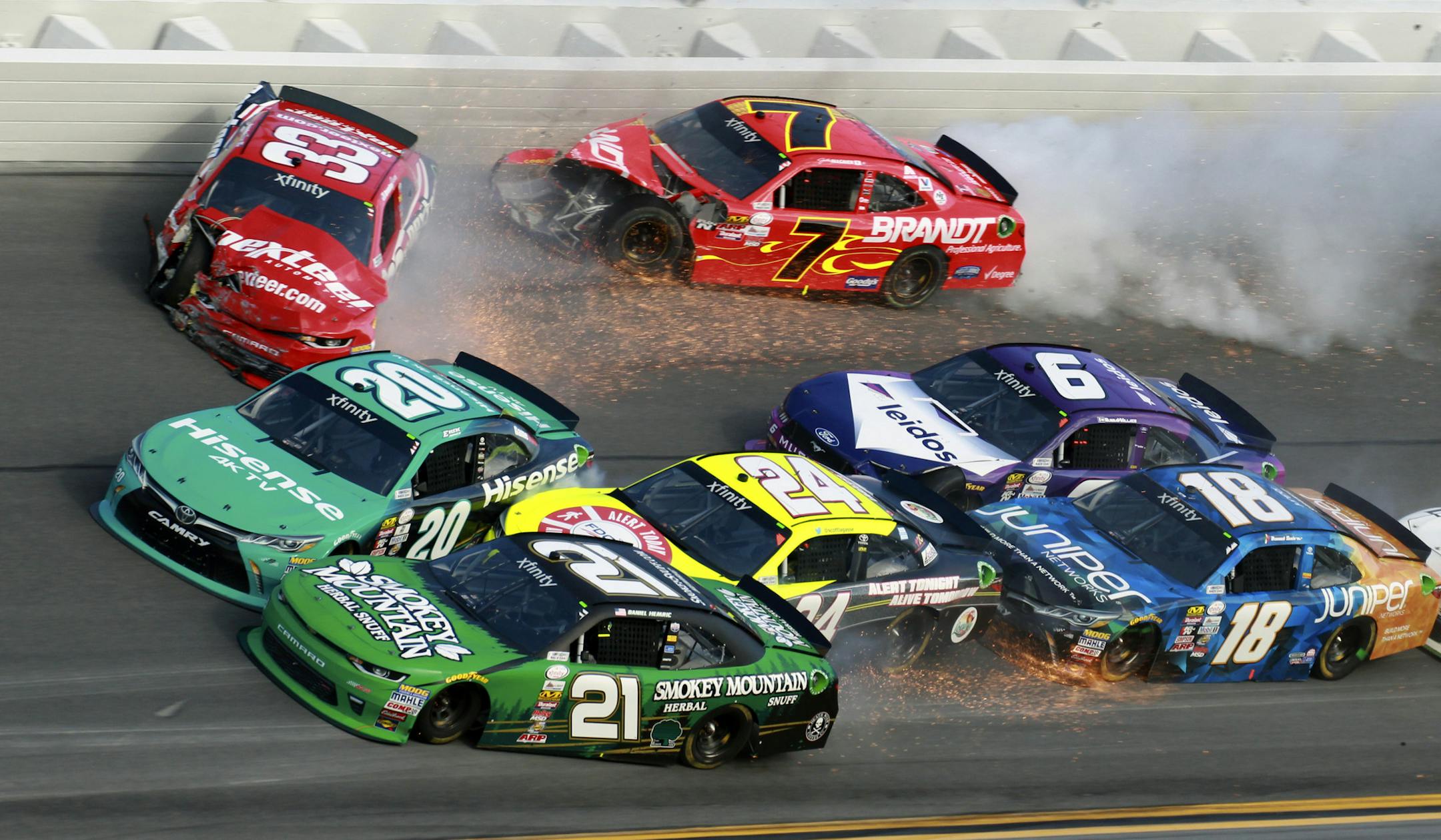 Daniel Hemric (21), Erik Jones (20), Brandon Jones (33), Scott Lagasse Jr (24), Justin Allgaier (7), Darrell Wallace Jr (6) and Daniel Suarez (18) crash during a NASCAR Xfinity series auto race at Daytona International Speedway in Daytona Beach, Fla., Saturday, Feb. 25, 2017. (AP Photo/John Chilton)