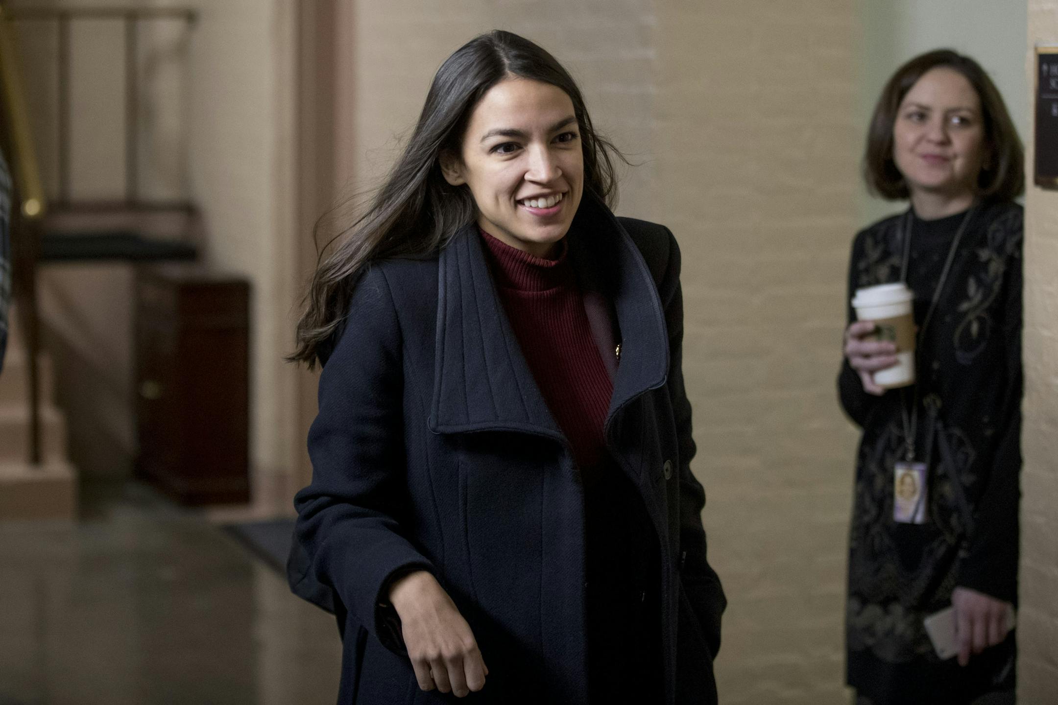 Rep. Alexandria Ocasio-Cortez, D-N.Y., arrives for a House Democratic Caucus meeting on Capitol Hill in Washington, Wednesday, Jan. 23, 2019. (AP Photo/Andrew Harnik)
