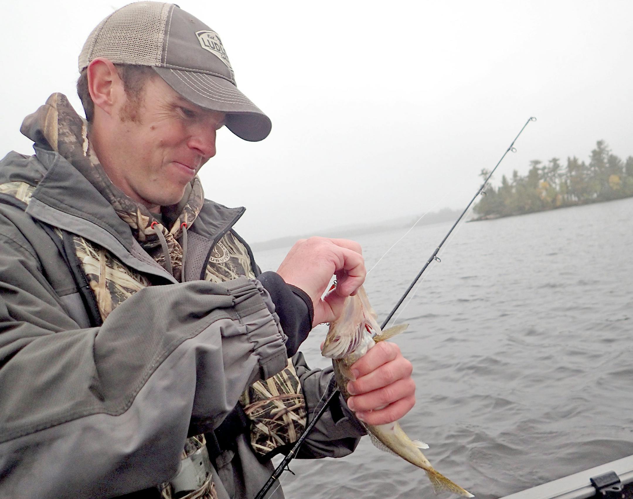 Jeremy Maslowski of Tower, Minn., unhooks a walleye caught on Lake Vermilion while trolling crankbaits with lead core fishing line. The method landed limits of the fish for Maslowski and his fishing partner during a recent cold front when the fish weren't biting on minnows and jigs.