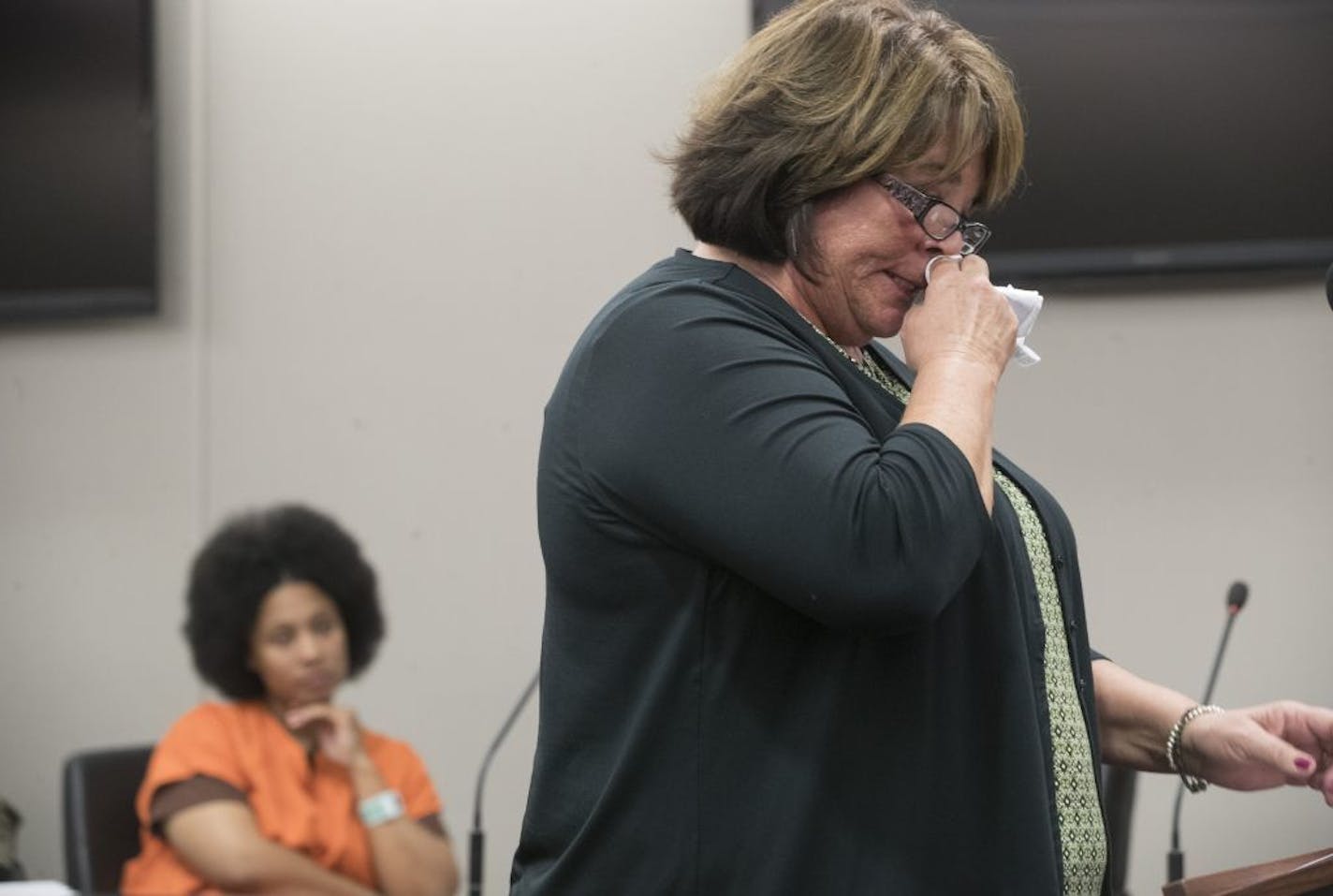 Colleen Ronnei, right, read a victim impact statement about her son Luke Ronnei, who died of a heroin overdose. The statement came Thursday during the sentencing of Beverly Burrell, at left.