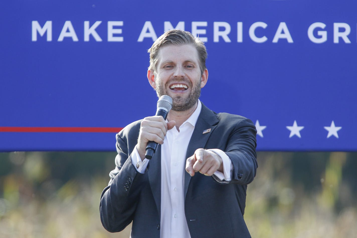 Eric Trump, the son of President Donald Trump, points to supporters as he speaks at a campaign rally for his father in Monroe, N.C., Thursday, Oct. 8, 2020. (AP Photo/Nell Redmond)