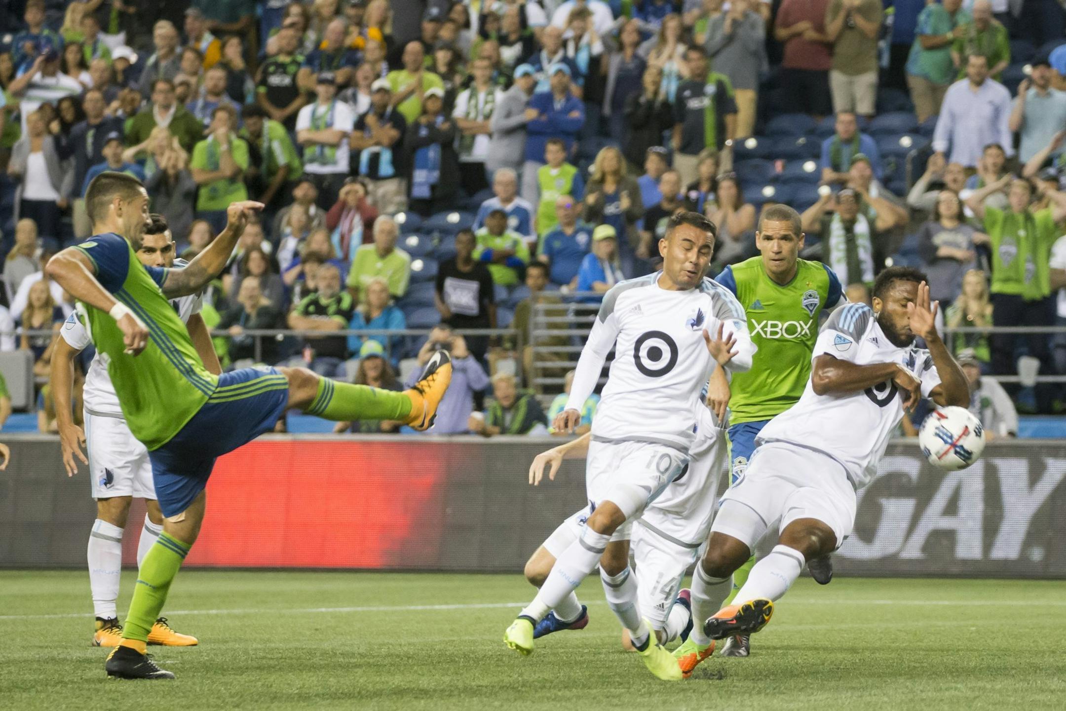 Minnesota United defender Jermaine Taylor commits a handball in the box to award the Sounders a penalty kick in stoppage time, on which Seattle Sounders' Clint Dempsey scored, to give the Sounders a 2-1 win in an MLS soccer match Sunday, Aug. 20, 2017, in Seattle. (Bettina Hansen/The Seattle Times via AP)