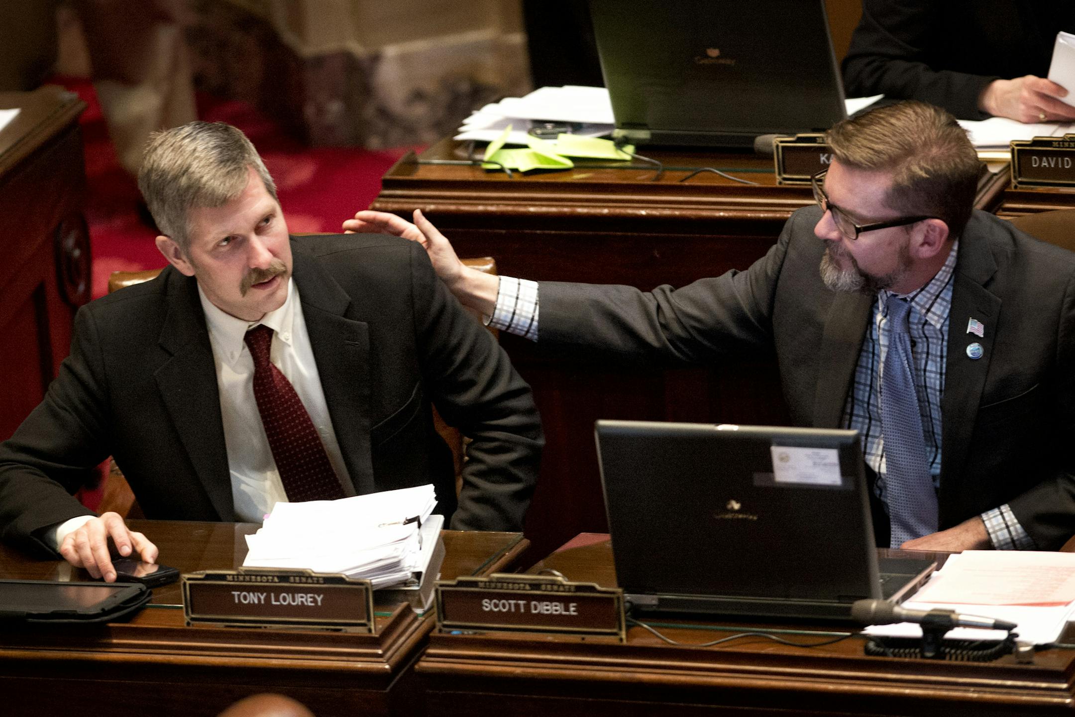 Sen Tony Dibble, right, congratulated bill author Sen. Tony Lourey after the final vote. The Minnesota Senate passed the health insurance exchange bill by a straight party line vote 39-28. Next stop is Governor Dayton's desk. Monday, March 18, 2013. ] GLEN STUBBE * gstubbe@startribune.com