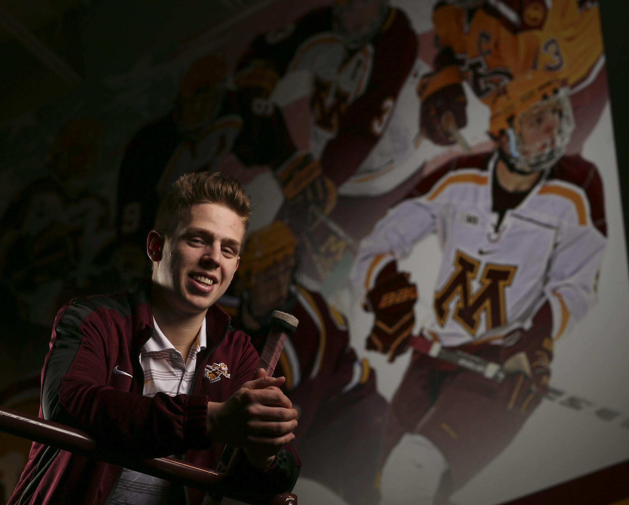 Gophers' junior defenseman Mike Reilly with the mural at Mariucci Arena where his image was added to the previous hockey All-America selections. ] JEFF WHEELER ï jeff.wheeler@startribune.com The Gophers' junior defenseman Mike Reilly is first team All-America and two-time Big Ten Defensive Player of the Year, photographed in front of the mural he's in at Mariucci Arena Wednesday afternoon, March 25, 2015.