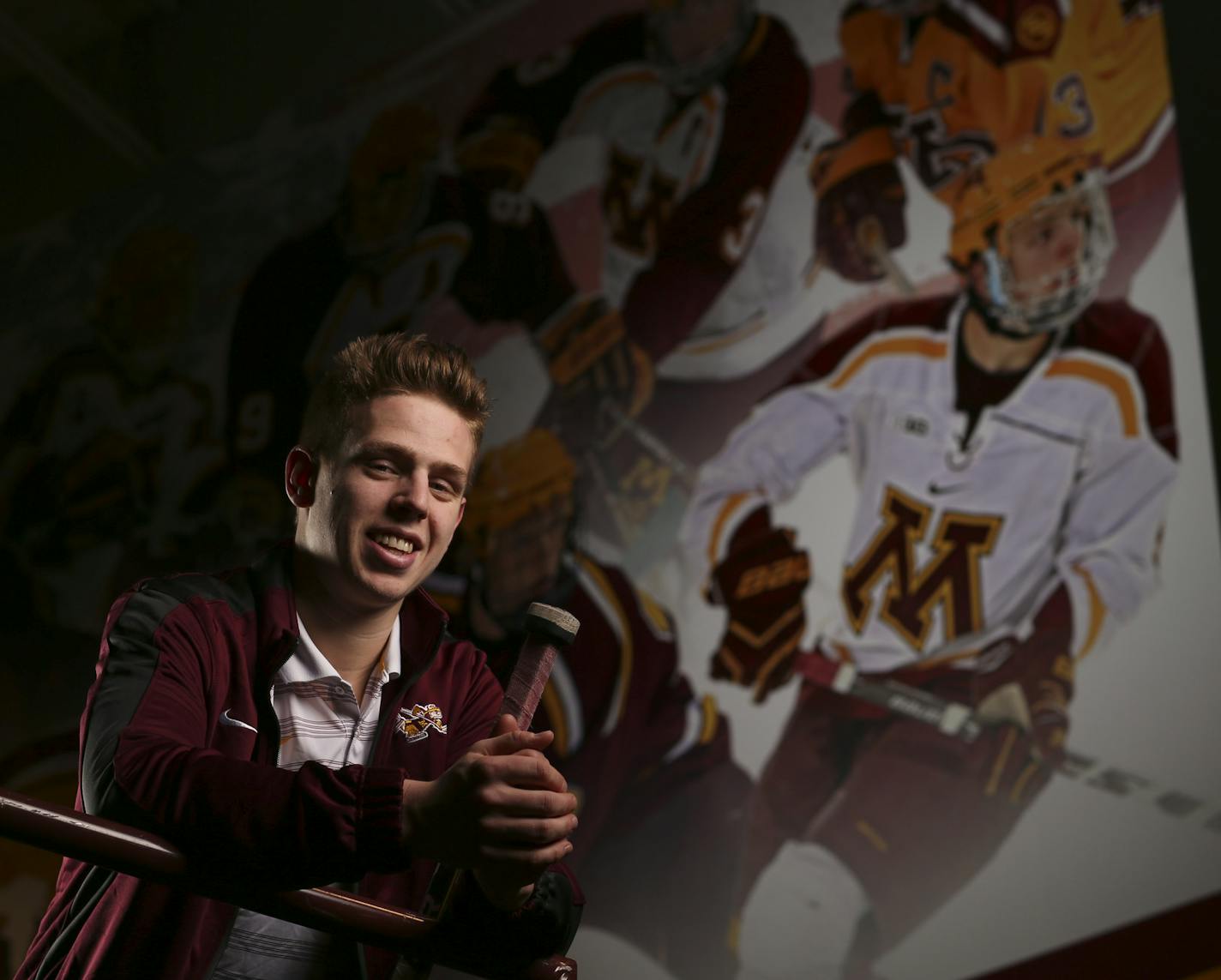 Gophers' junior defenseman Mike Reilly with the mural at Mariucci Arena where his image was added to the previous hockey All-America selections. ] JEFF WHEELER &#xef; jeff.wheeler@startribune.com The Gophers' junior defenseman Mike Reilly is first team All-America and two-time Big Ten Defensive Player of the Year, photographed in front of the mural he's in at Mariucci Arena Wednesday afternoon, March 25, 2015.