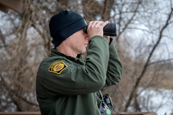 Jared Berg, a supervisor for border patrol agents at the Warroad station, observes activity on Lake of the Woods from an observation deck in Warroad, 