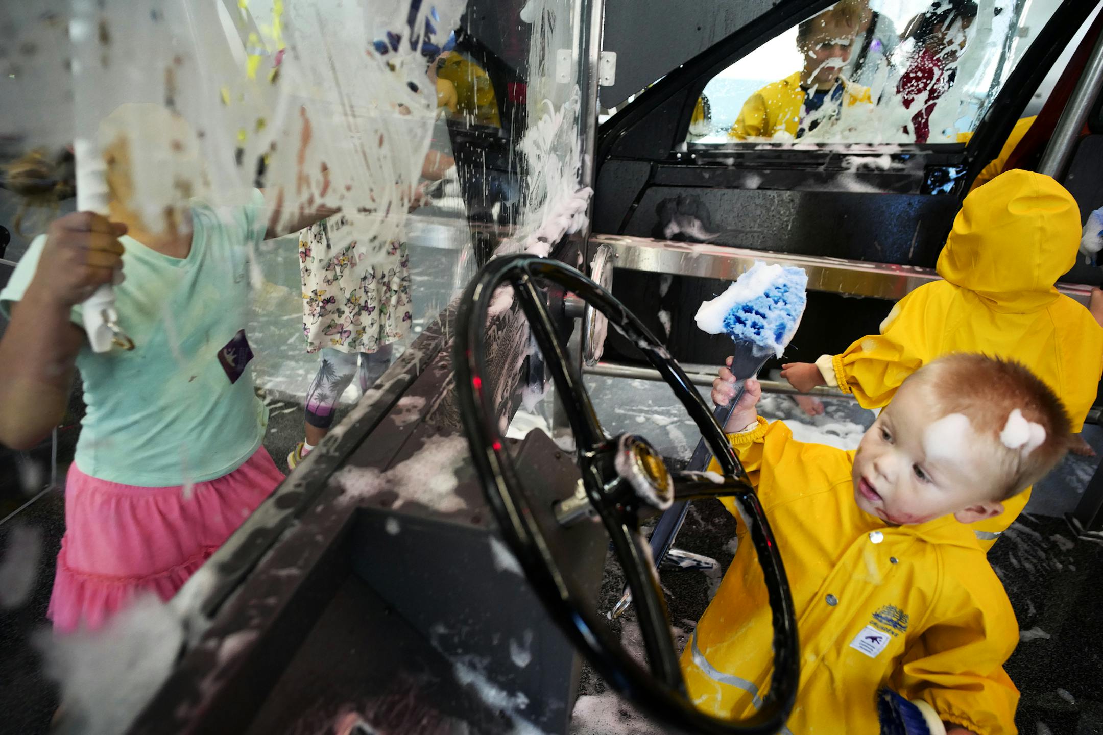 Croix Xavier,2.5, of Richmond, Wisconsin, gets a kick out of the the car wash. It is part of the first exhibit, called "Forces at Play," invites visitors to test out various displays that pose challenges in science, technology and engineering -- sans directions.]RichardTsong-Taatarii richard.tsong-taatarii@startribune.com
