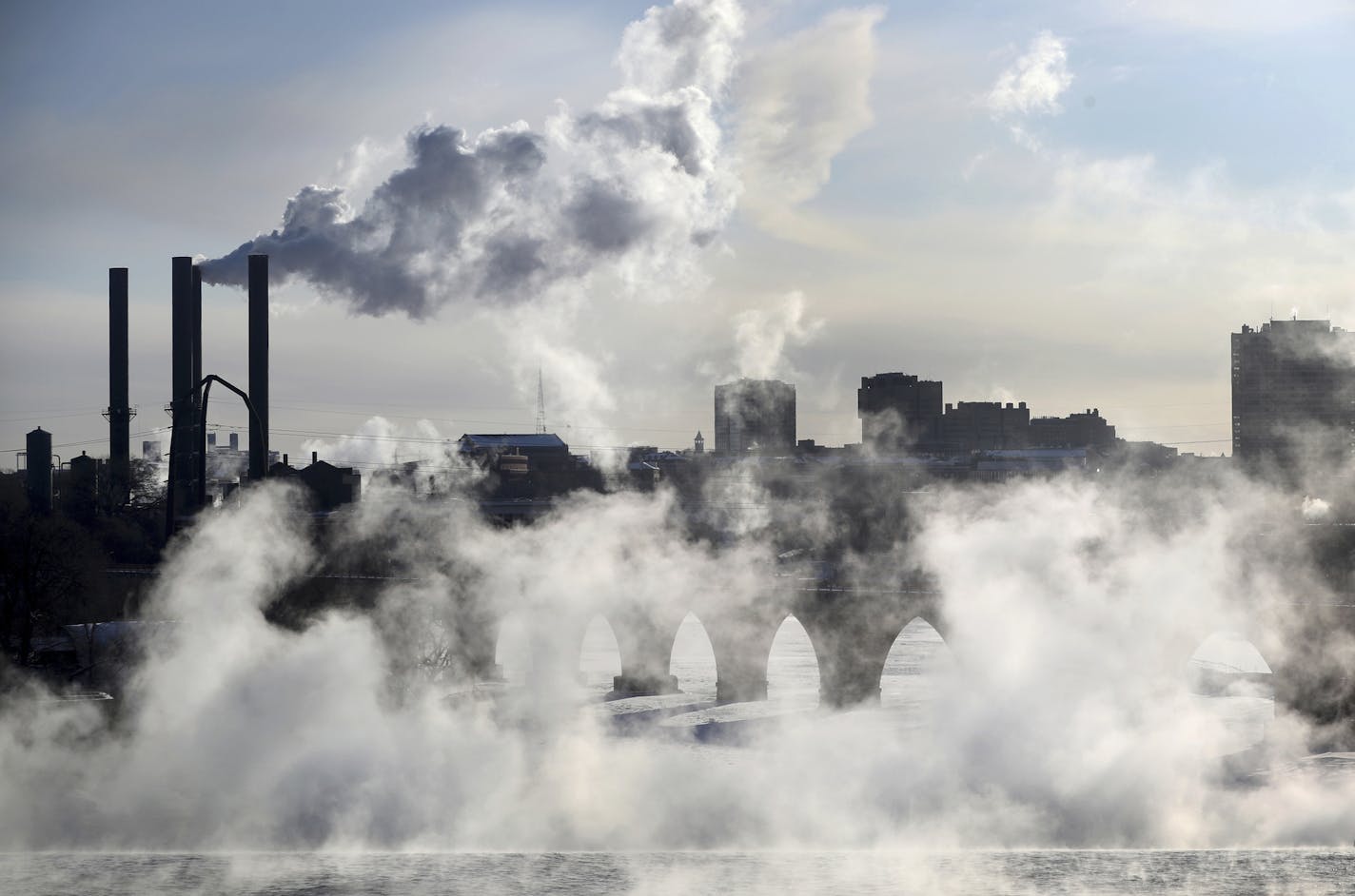 Water vapor rises above St. Anthony Falls on the Mississippi River as the Stone Arch Bridge is obscured, seen from the Third Ave. Bridge Tuesday, Jan. 29, 2019, In Minneapolis. Extreme cold and record-breaking temperatures are crawling into parts of the Midwest after a powerful snowstorm pounded the region, and forecasters warn that the frigid weather could be life-threatening. (David Joles/Star Tribune via AP)