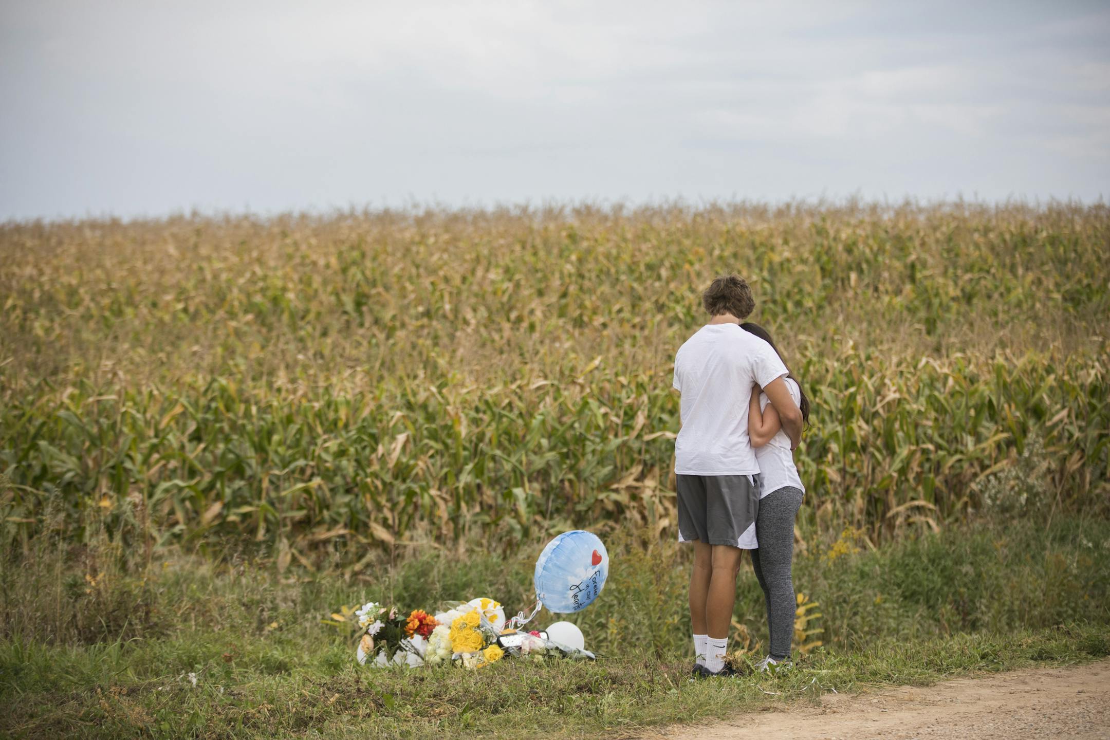 Abby Spanier and Nick Mostrom, friends of 16-year-old Ja'Mason Moffett, hugged as they gathered with friends at the spot where a memorial was made near where he died in a car accident the day after the accident on Friday, September 15, 2017, Shakopee, Minn. The students were wearing white in his honor. Friends described him as a funny guy who was a big Duke University fan and would regularly wear color coordinated glasses with popped out lenses. ] RENEE JONES SCHNEIDER • renee.jones@start