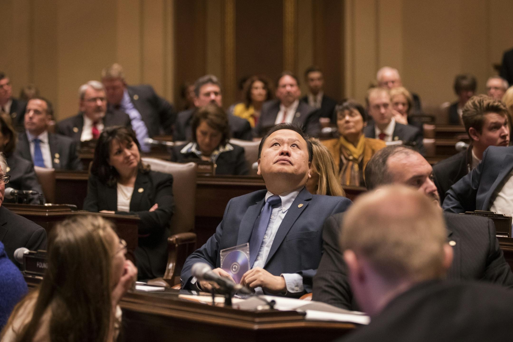 Sen. Foung Hawj, DFL-St. Paul, center, and other senators look at the renovations in the Minnesota Senate chambers during the session.
