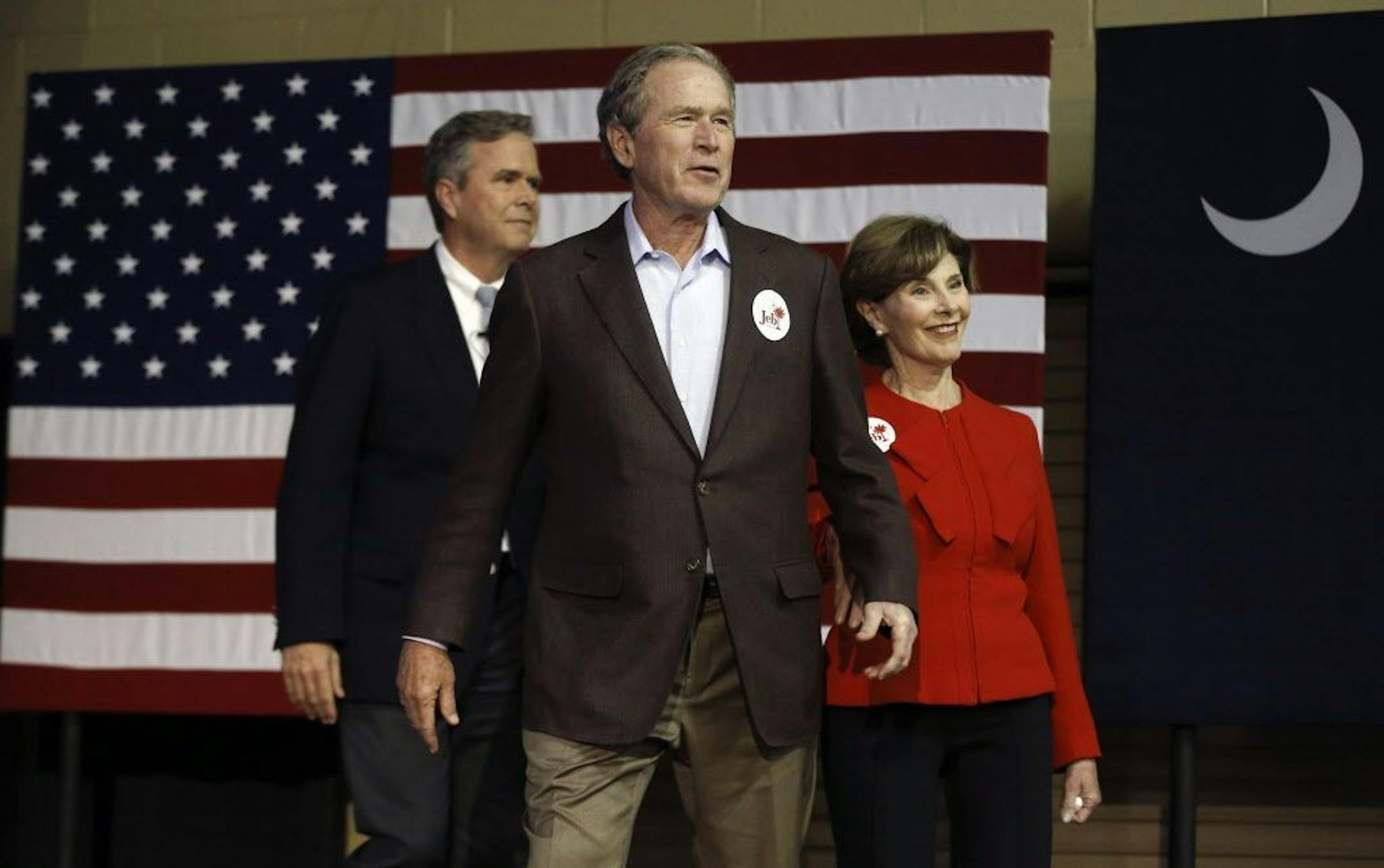 Republican presidential candidate and former Florida Gov. Jeb Bush, left, accompanied by his brother former President George W. Bush, center, and George's wife Laura Bush take the stage during a campaign stop Monday, Feb. 15, 2016, in North Charleston, S.C.