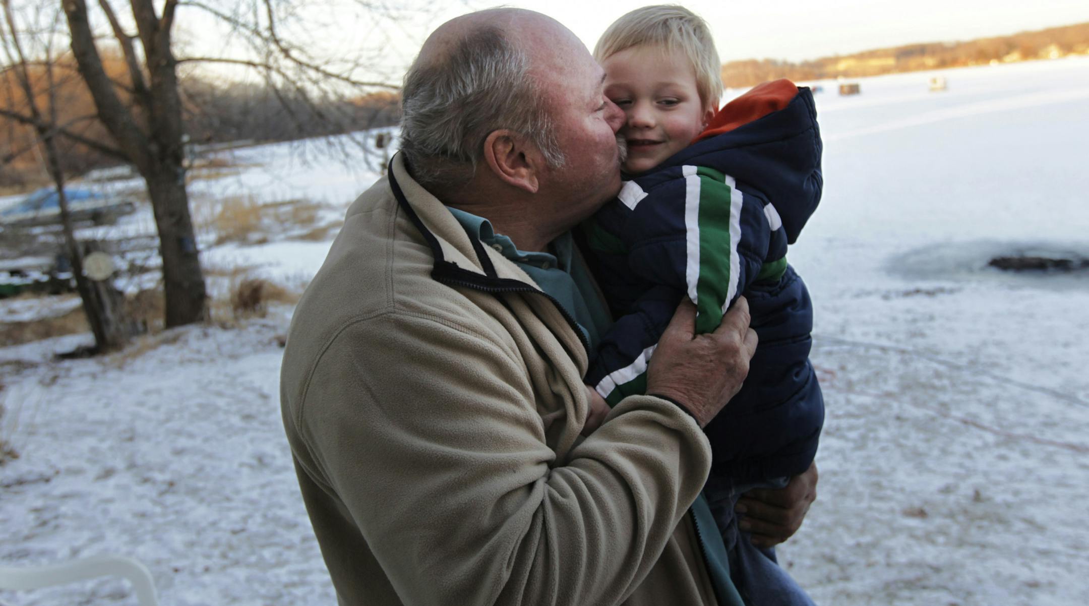 Lowell Johnson kissed his 3-year-old grandson Brody Lerdon as he reflected on Saturday night's search for two snowmobilers.