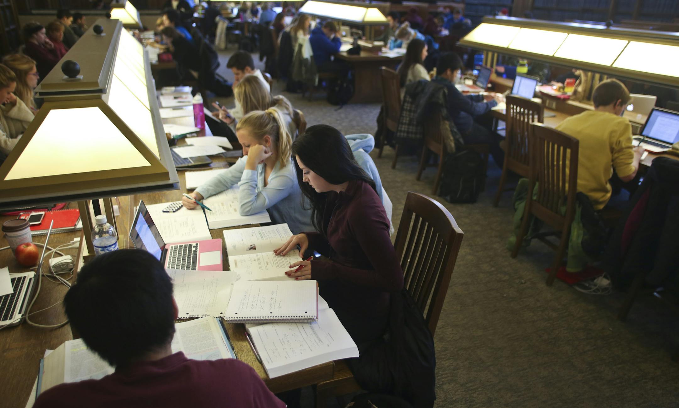 Sophomore Sarah Larrive studied for an organic chemistry test with friend Samantha Kallenbach (in blue) at Walter Library at the University of Minnesota in Minneapolis, Minn., on Thursday, December 12, 2013. Ten years ago, less than a third of the students at the U of M graduated in four years -one of the poorest rates in the Big Ten. Since then, the graduation rate has nearly doubled - putting the U within "striking distance" of the 60% goal set by the Board of Regents. ] RENEE JONES SCHNEIDER