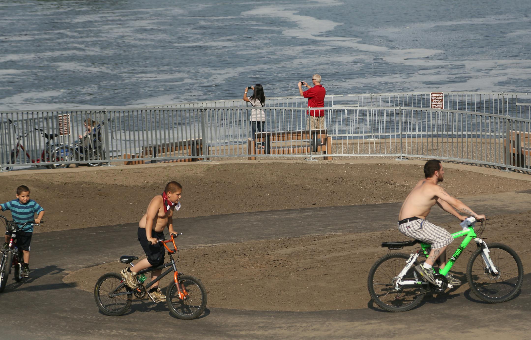 People biked and walked as they toured the new walkway and viewing areas on the Coon Rapids Dam.