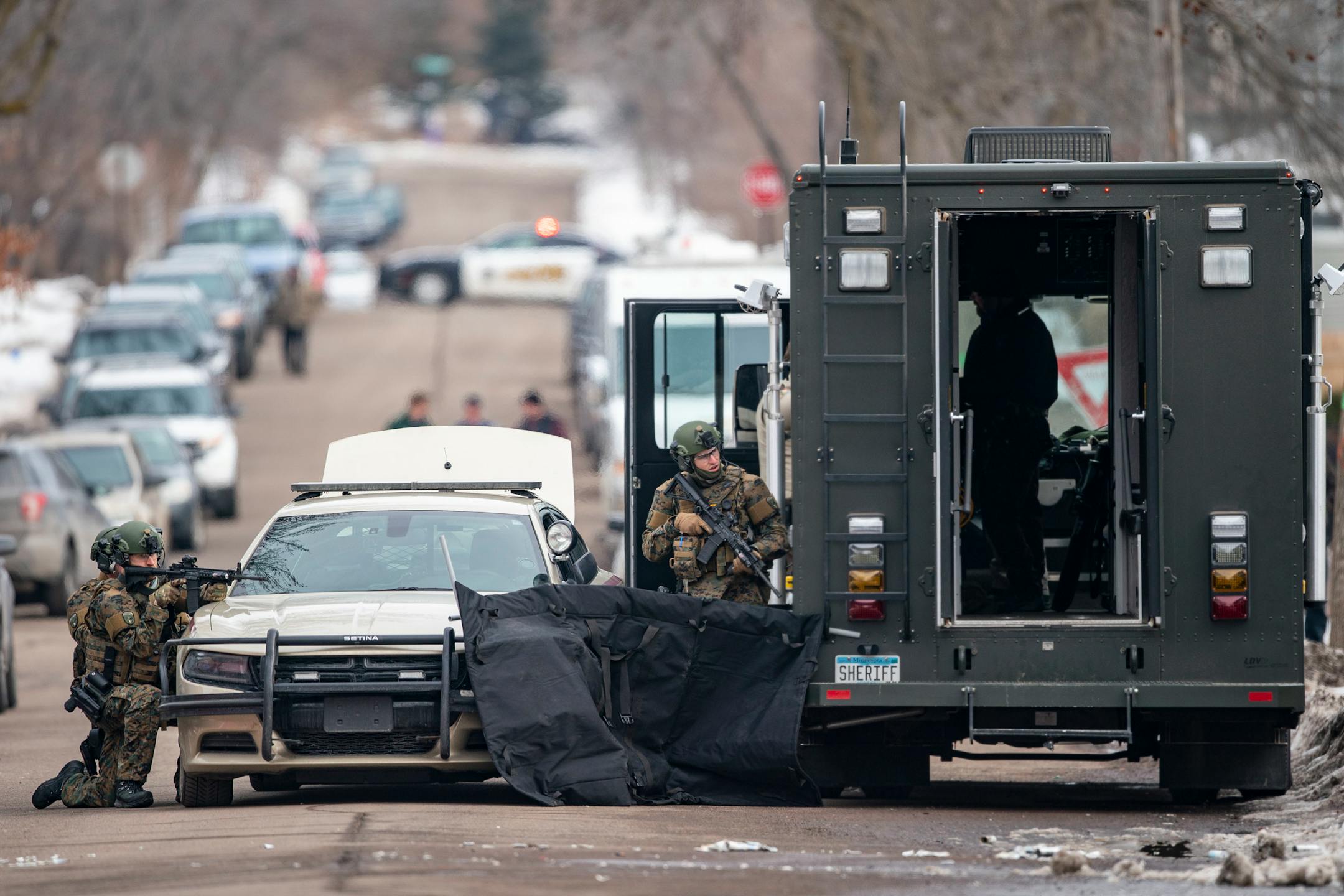 St. Louis County sheriffs were armed with rifles and grenade launchers as they maintained a perimeter and attempted to force the gunman out of his house.