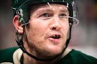Minnesota Wild left wing Matt Cooke (24) trades obscenities with Winnipeg Jets left wing Evander Kane (9) from the Wild bench in the third period. ] A