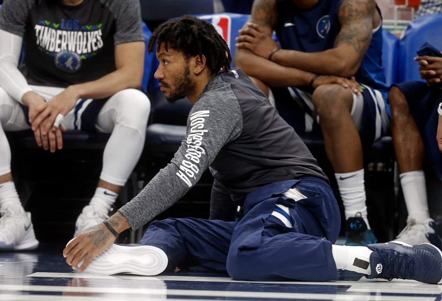 Newly signed Timberwolves' player Derrick Rose watches in the second half