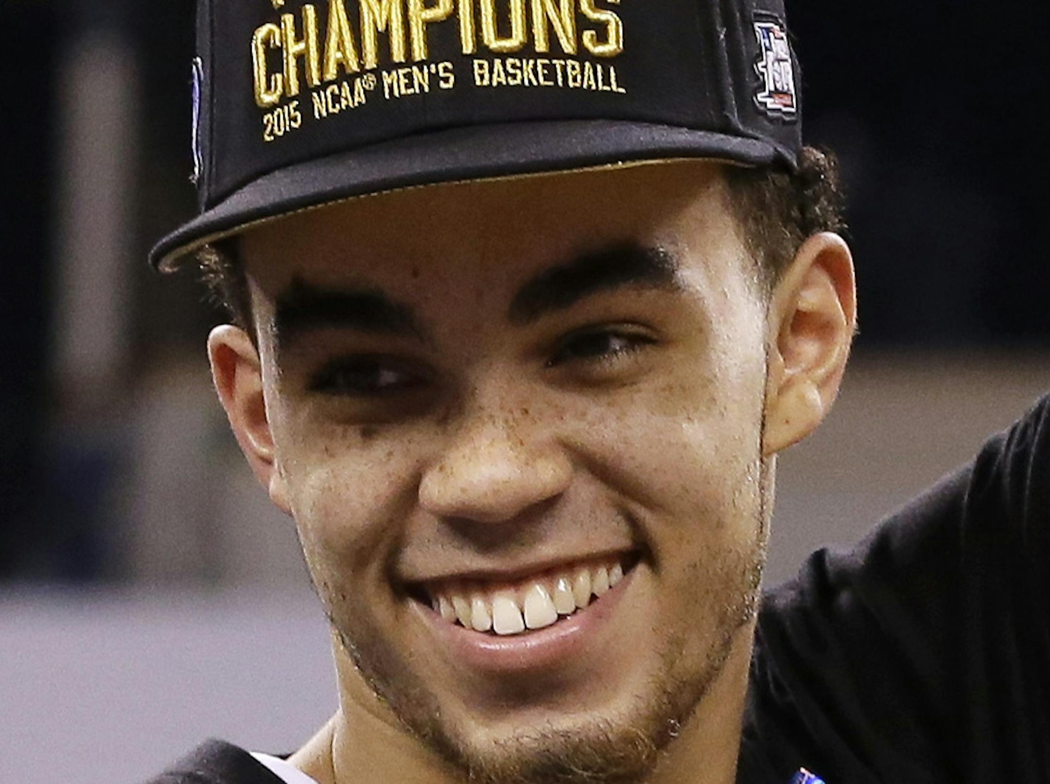 Duke's Tyus Jones cuts down the net after his team's 68-63 victory over Wisconsin in the NCAA Final Four college basketball tournament championship game Monday, April 6, 2015, in Indianapolis. (AP Photo/David J. Phillip)