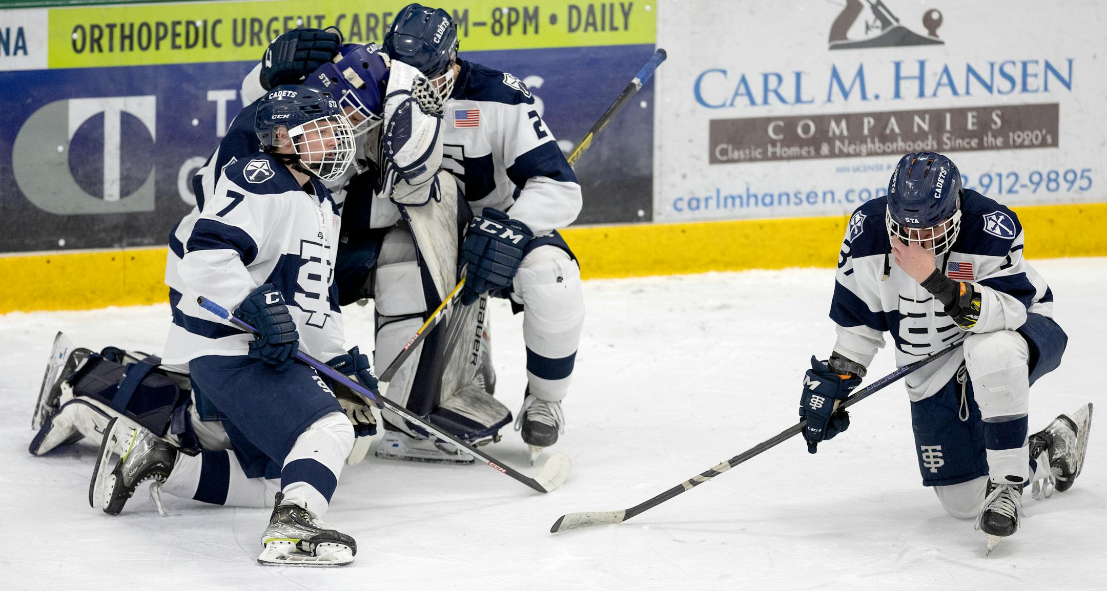 St. Thomas Academy players react at the end of the boy's hockey section 3 Class 2A Finals.