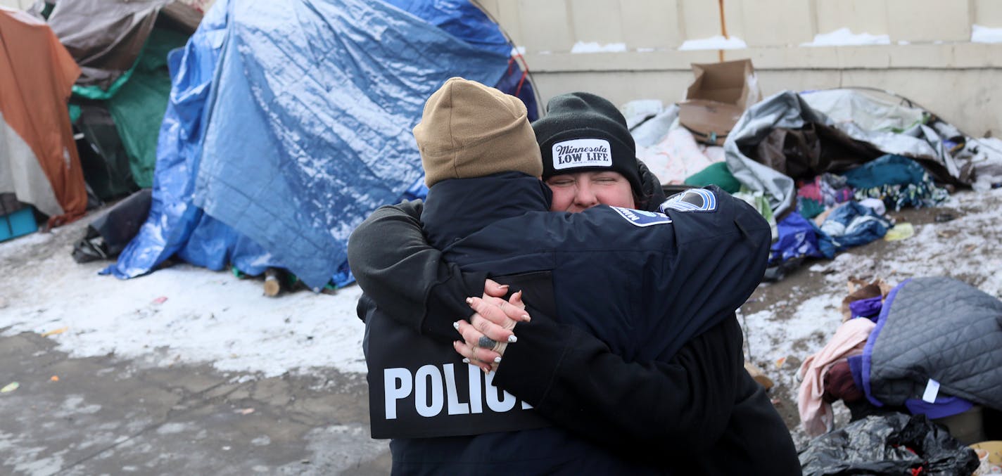 It was moving day for some at the Hiawatha homeless encampment and a day of joy and emotion for some Tuesday, Dec. 11, 2018, in Minneapolis, MN. Here, Jenny Bjorgo, the camp outreach coordinator for Minnesota Indian Women's Resource Center, hugs Minneapolis Police Sgt. Grant Snyder as the move began. Bjorgo told Grant that they and other agencies had cooperated to care for and move an entire community of homeless, something Bjorgo said "had never been done before" in the United States.] DAVID JO