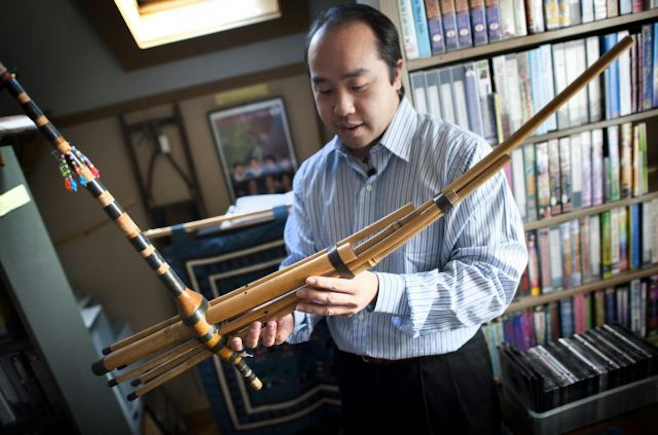 Kou Xiong, archivist for a collection of Hmong artifacts held a qeej, a Hmong musical instrument.