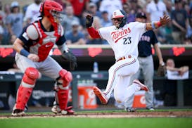 Twins third baseman Royce Lewis slides home safely after a single by Christian Vázquez in the bottom of the second inning