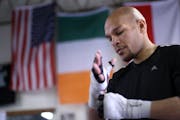 Caleb Truax wrapped his hands before he began his workout at Lyke's Anoka-Coon Rapids Boxing Gym in Coon Rapids Monday afternoon.