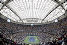 FILE- In this Sept. 6, 2017 file photo, fans fill the stands at Arthur Ashe stadium as Karolina Pliskova, of Czech Republic, plays CoCo Vandeweghe, of