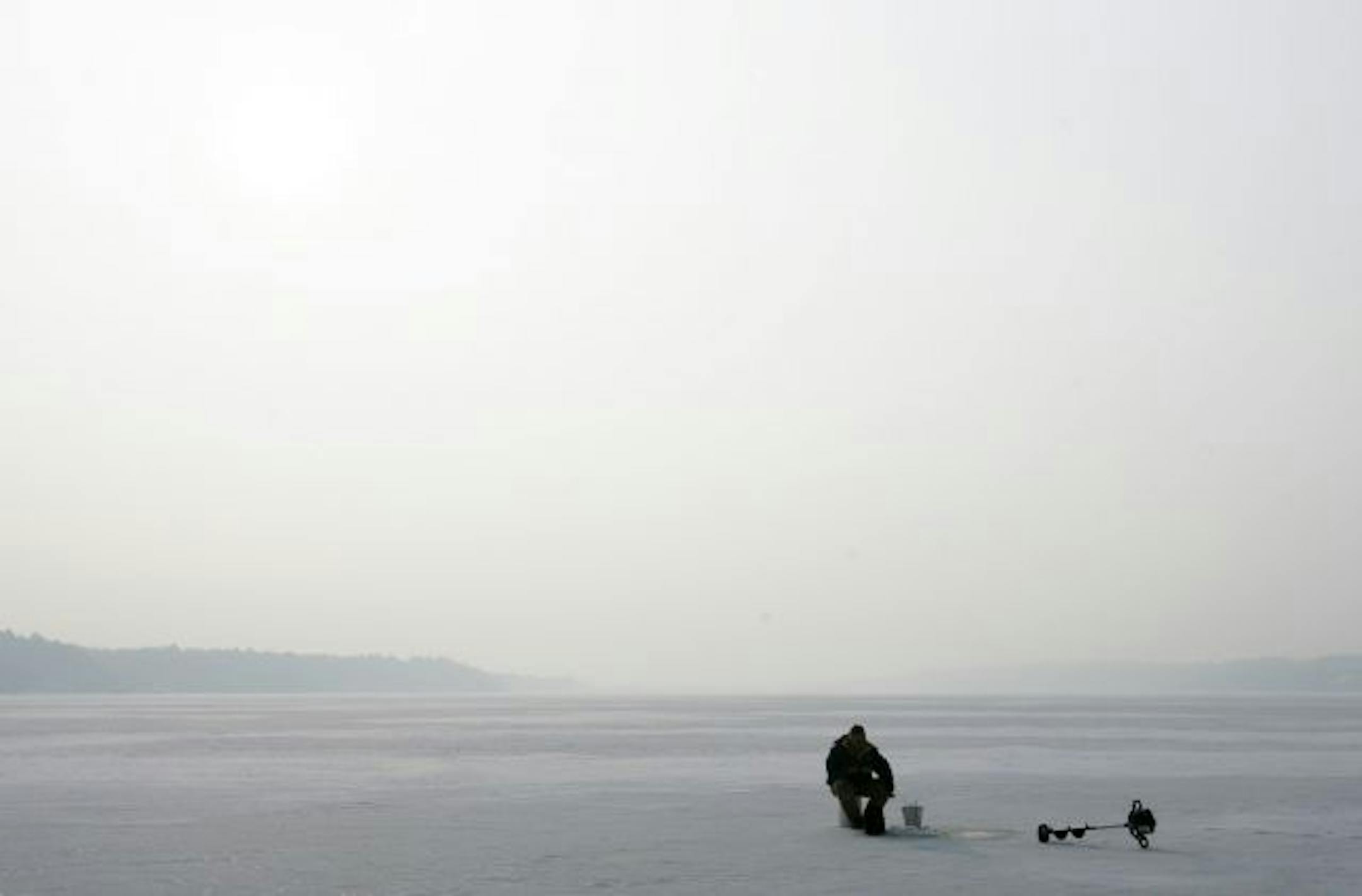 Tom Auger of Lake Elmo sat in the stillness on the St. Croix River, Dec. 18, 2007.