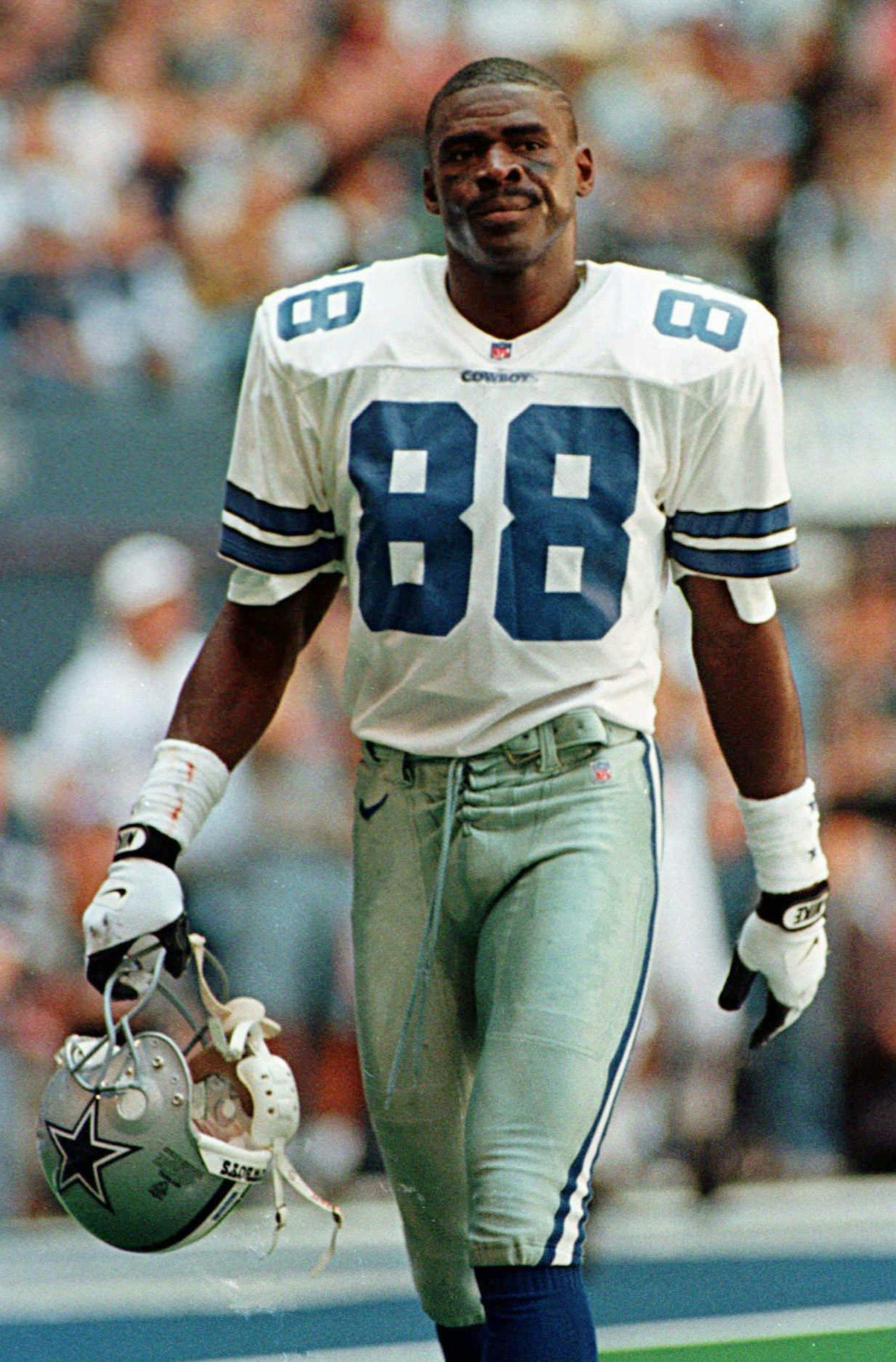 Dallas Cowboys receiver Michael Irvin walks off the field after the team failed to make a first down against the Arizona Cardinals during the second quarter in Irving, Texas, Sunday, Oct. 13, 1996. Irvin returned to the Cowboys after a five-game suspension. The Cowboys won 17-3. (AP Photo/Linda Kaye) ORG XMIT: IRV112