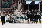 A fight breaks out between the San Jose Sharks and the Minnesota Wild during the second period of an NHL hockey game Thursday, Nov. 7, 2019, in San Jo